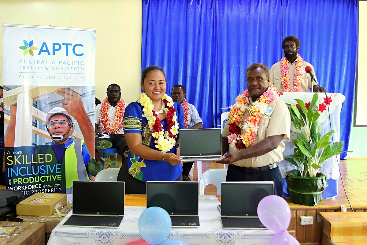 APTC Country Director for Solomon Islands and Kiribati, Abigail Chang, presents laptops to Batuna Rural Training Centre Principal, Ibi Drelly, at the handover ceremony in the Western Province, Solomon Islands.